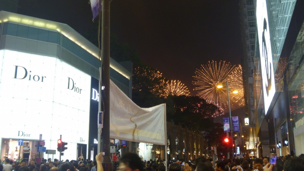 Designer brands on Canton Road with national day fireworks in the background